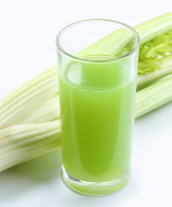 Pohár čerstvo pripraveného zelerového džúsu vedľa zelerových stoniek, ideálny pre rehydratáciu tela a doplnenie elektrolytov. Zelerová šťava podporuje detoxikáciu a udržanie rovnováhy pH organizmu.